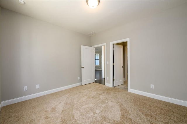 unfurnished bedroom with light colored carpet