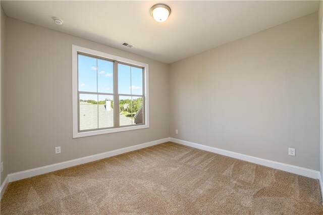 unfurnished room with carpet floors