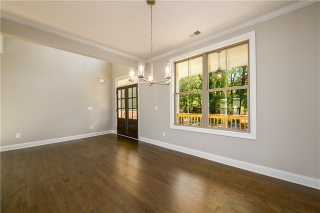 unfurnished dining area featuring an inviting chandelier, dark hardwood / wood-style floors, french doors, and crown molding