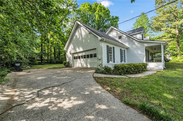 view of home's exterior featuring an attached garage, a lawn, and concrete driveway