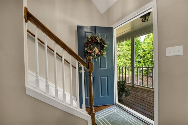 foyer with lofted ceiling and stairway