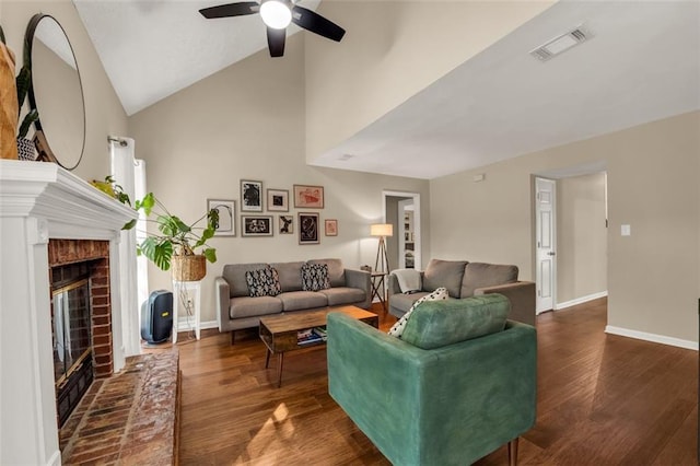 living area with ceiling fan, a fireplace, baseboards, visible vents, and dark wood-style floors