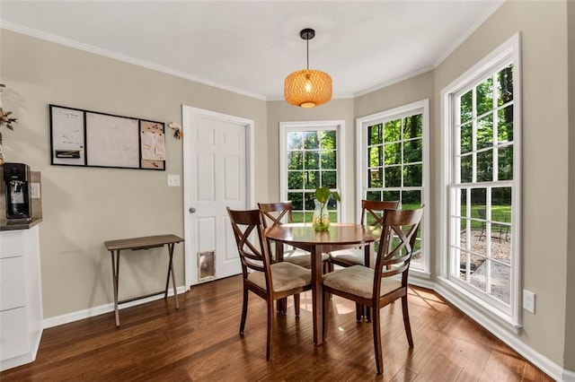 dining area featuring a healthy amount of sunlight, baseboards, ornamental molding, and dark wood-type flooring