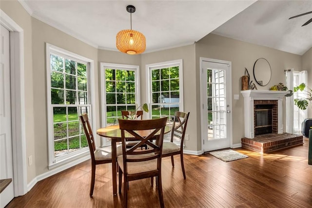 dining space featuring a ceiling fan, a healthy amount of sunlight, and wood finished floors
