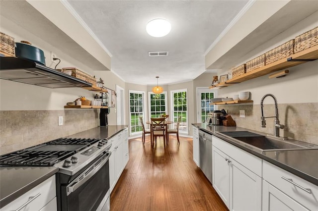 kitchen featuring open shelves, dark countertops, and stainless steel appliances