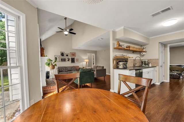 dining space with visible vents, a ceiling fan, dark wood-style flooring, and crown molding