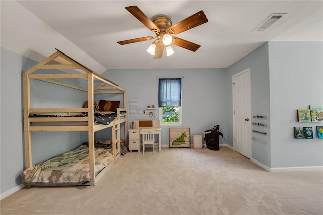 carpeted bedroom featuring baseboards, ceiling fan, and visible vents