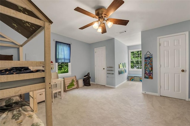 bedroom with carpet floors, baseboards, visible vents, and ceiling fan