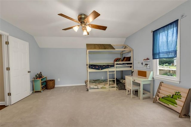 carpeted bedroom with baseboards, ceiling fan, and vaulted ceiling