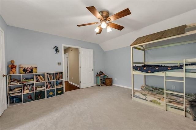 bedroom featuring carpet floors, baseboards, vaulted ceiling, and ceiling fan