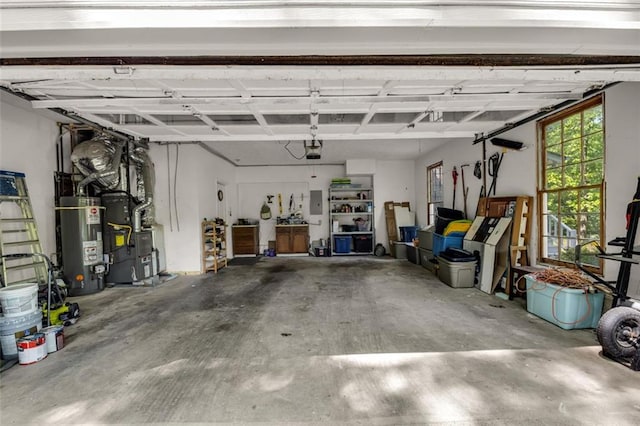 garage with a garage door opener, heating unit, and gas water heater