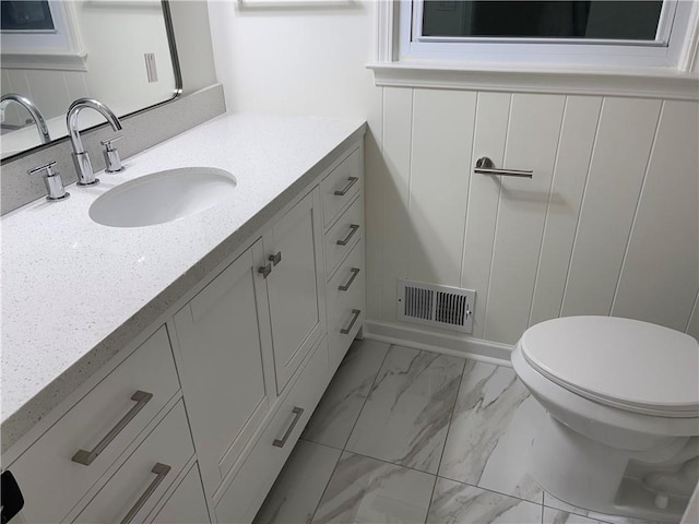 bathroom with vanity and toilet