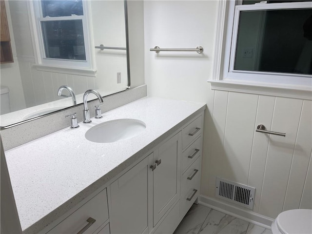 bathroom featuring vanity and toilet