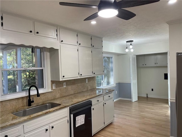 kitchen with white cabinetry, dishwasher, plenty of natural light, and sink