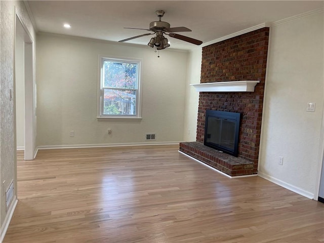 unfurnished living room featuring a fireplace, light hardwood / wood-style flooring, ceiling fan, and ornamental molding