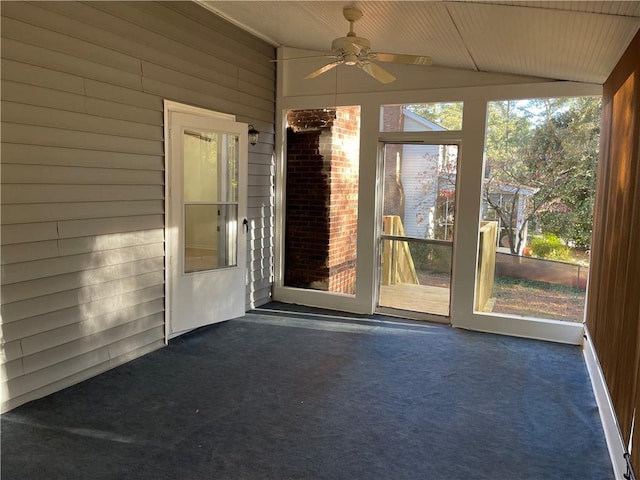 unfurnished sunroom with vaulted ceiling and ceiling fan