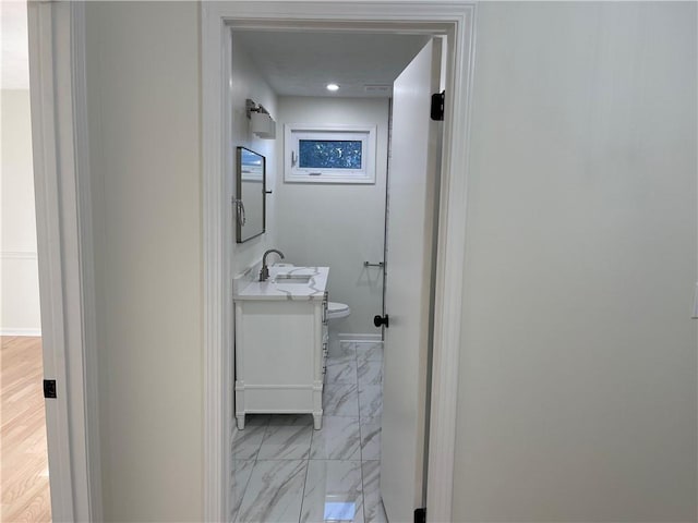 hall featuring light hardwood / wood-style flooring and sink