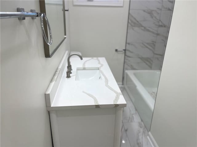 bathroom with vanity and tiled shower / bath combo