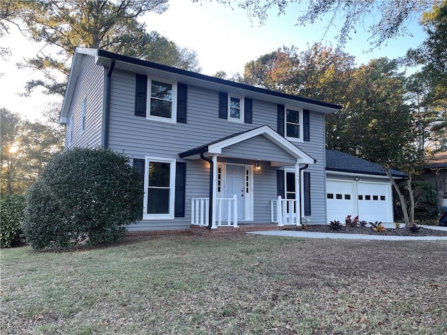 view of front of home featuring a front yard and a garage