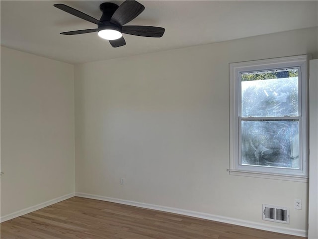 spare room featuring light wood-type flooring and ceiling fan