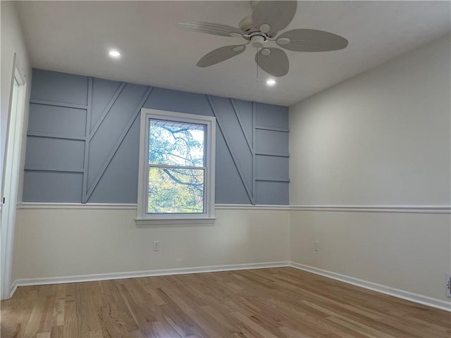 additional living space with light hardwood / wood-style flooring and ceiling fan