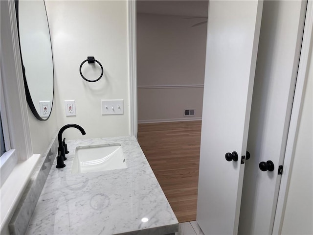 bathroom with hardwood / wood-style flooring and vanity