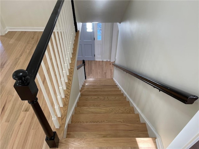 stairs featuring hardwood / wood-style floors