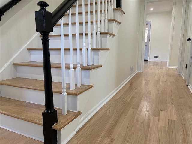 stairs with wood-type flooring