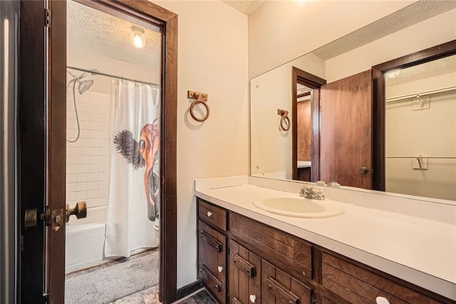 bathroom featuring vanity, toilet, shower / bath combo, and a textured ceiling