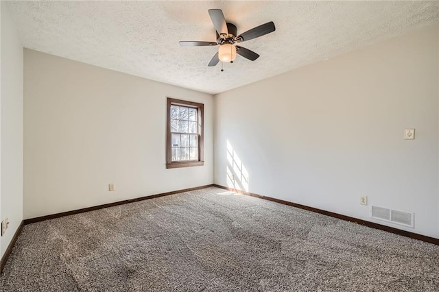 spare room with visible vents, a textured ceiling, carpet, baseboards, and ceiling fan