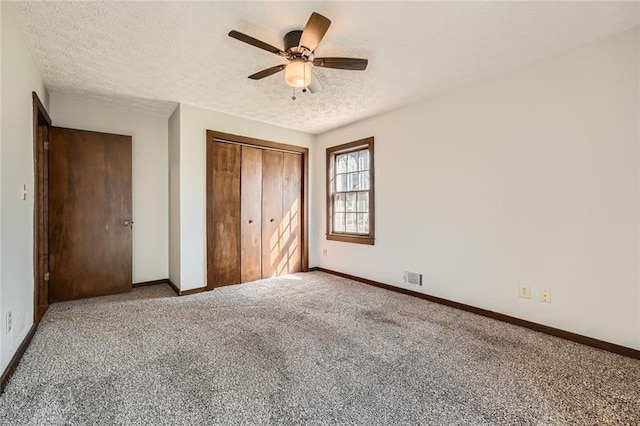 unfurnished bedroom with baseboards, visible vents, a closet, and a textured ceiling