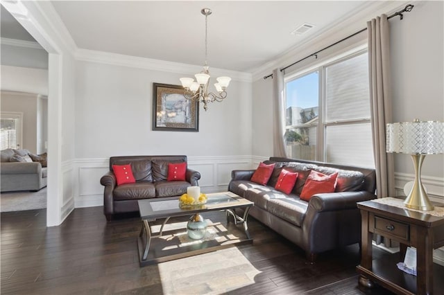 living room with plenty of natural light, visible vents, and crown molding