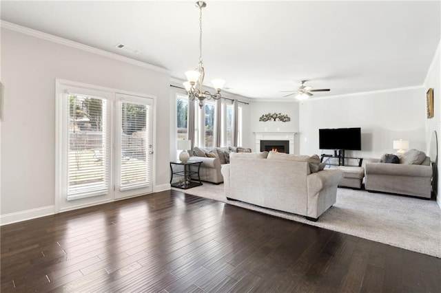 living room featuring a warm lit fireplace, baseboards, ornamental molding, and dark wood-type flooring