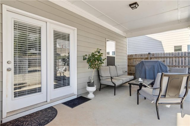 view of patio with fence and a grill