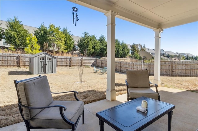 view of patio / terrace featuring a shed, an outdoor structure, and a fenced backyard