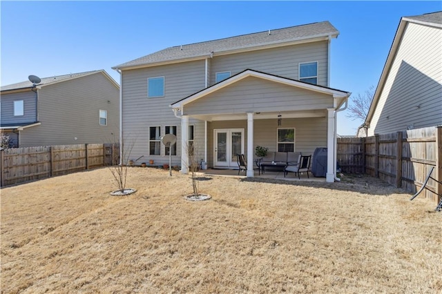 rear view of house featuring a patio, french doors, and a fenced backyard