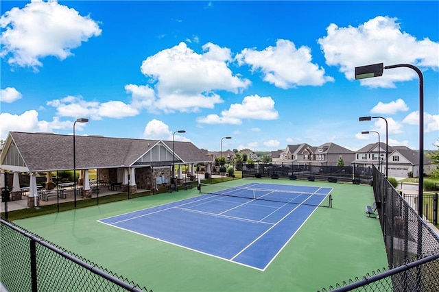 view of sport court featuring a residential view and fence