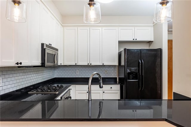 kitchen with backsplash, white cabinetry, pendant lighting, and appliances with stainless steel finishes