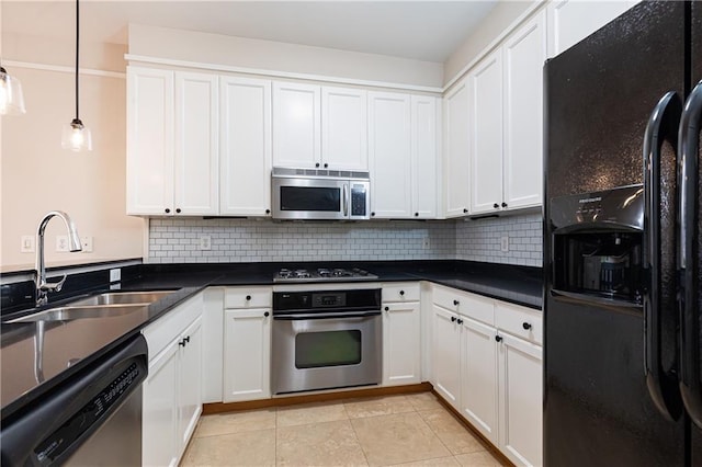 kitchen with white cabinets, appliances with stainless steel finishes, hanging light fixtures, and sink