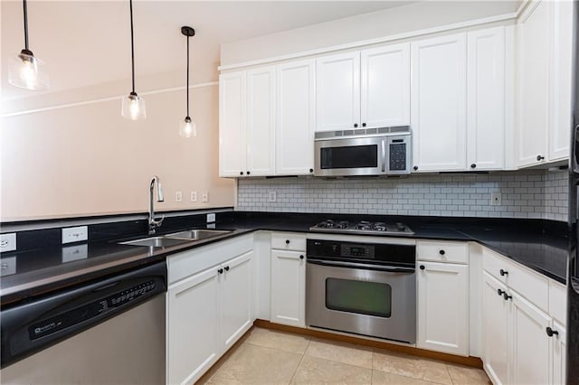 kitchen with white cabinets, sink, hanging light fixtures, decorative backsplash, and stainless steel appliances