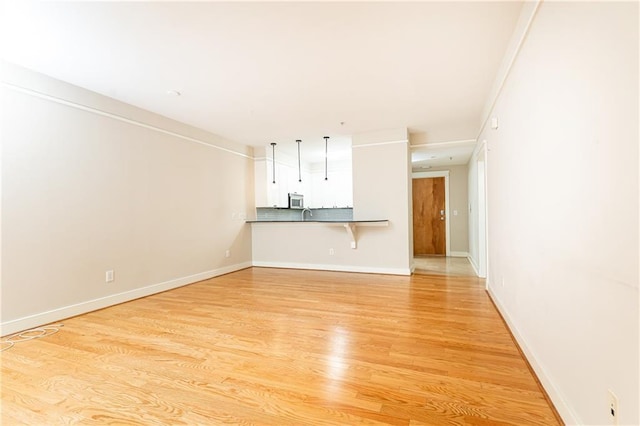 unfurnished living room featuring light hardwood / wood-style flooring