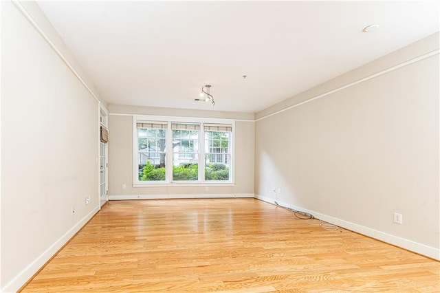 empty room with light hardwood / wood-style floors