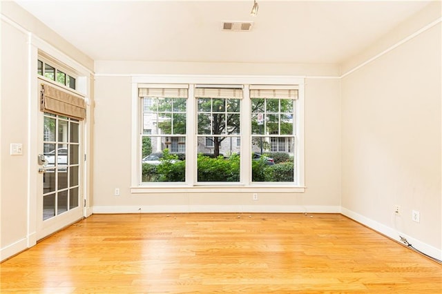 empty room with light hardwood / wood-style flooring