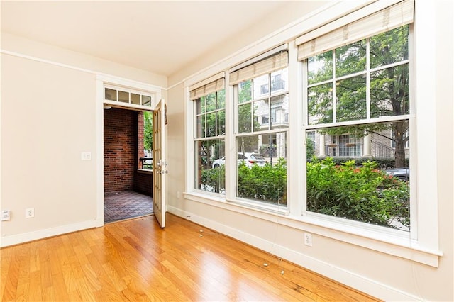 unfurnished room with light hardwood / wood-style flooring