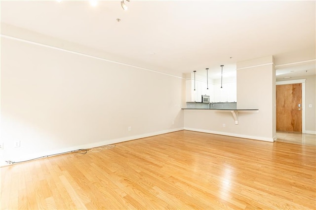 unfurnished living room with light wood-type flooring