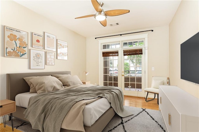 bedroom featuring ceiling fan, french doors, and light wood-type flooring