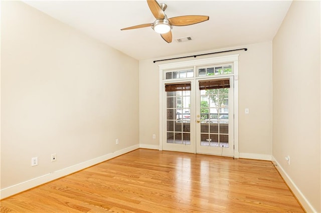 empty room featuring ceiling fan, light hardwood / wood-style floors, and french doors