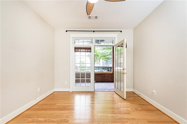 unfurnished room featuring ceiling fan, light hardwood / wood-style floors, and french doors