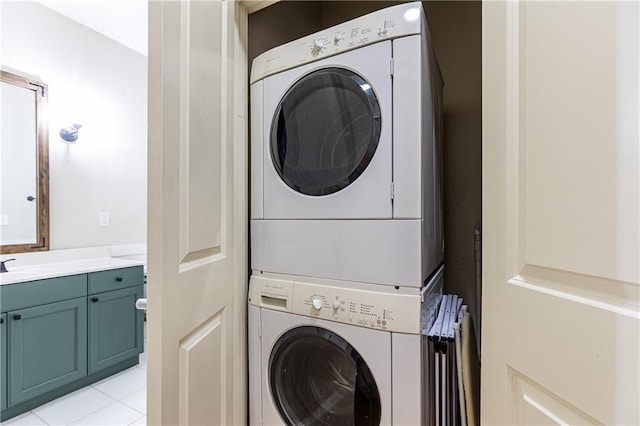 washroom featuring stacked washer and dryer, light tile patterned floors, and sink