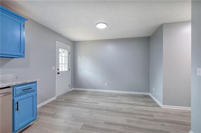 128 Evergreen Trl Unit 4, Cartersville, GA 30121 - unfurnished dining area with light wood-style flooring, a textured ceiling, and baseboards